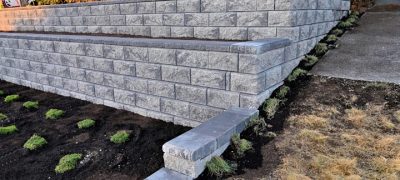 beautiful hardscape design in the front yard, two tier concrete retaining wall